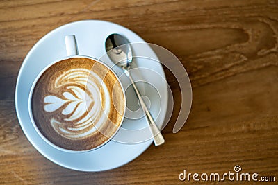 A cup of coffee on old wooden table in cafe coffee break in morning Stock Photo