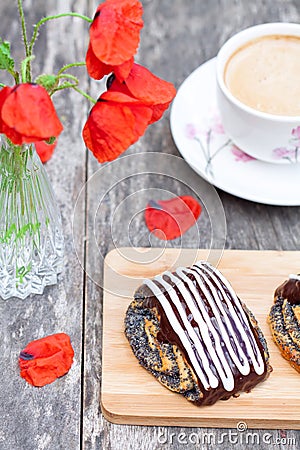 Cup of coffee with poppy buns glazed with chocolate and poppy fl Stock Photo