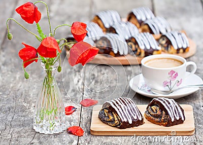 Cup of coffee with poppy buns glazed with chocolate and poppy fl Stock Photo