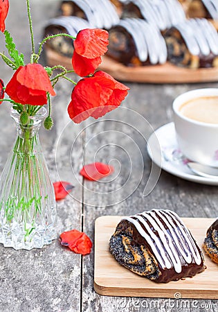 Cup of coffee with poppy buns glazed with chocolate and poppy fl Stock Photo