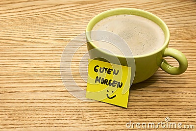 Cup of coffee, post-it note good morning and smiley Stock Photo