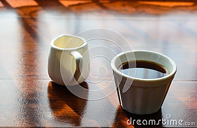 A cup of coffee and a pot of huney Stock Photo