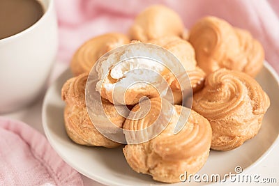 A cup of coffee with profiteroles. Morning coffee. Tender composition with coffee. A cup of coffee on a table Stock Photo