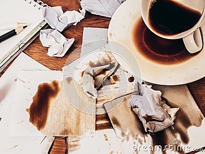Cup of coffee spilt on wood table, top view. Stock Photo