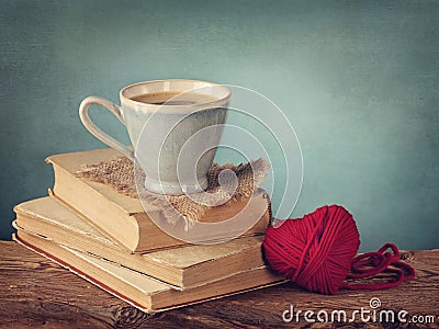 Cup of coffee standing on old books Stock Photo
