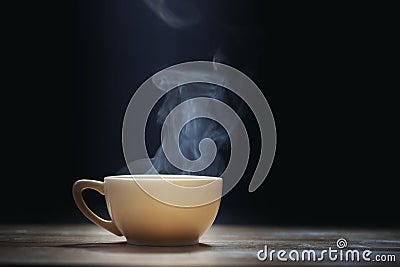 Cup of coffee with steam on black Stock Photo