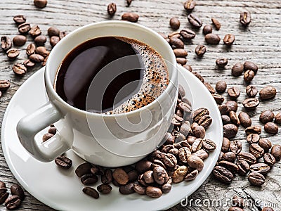 Cup of coffee surrounded by coffee beans. Top view. Stock Photo