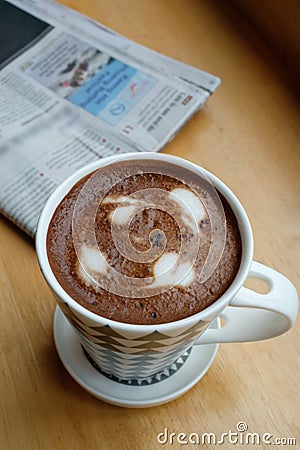 A cup of coffee on the table with newspaper Stock Photo