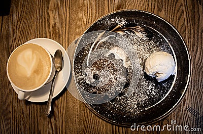 Cup of coffee on a white saucer with chocolate muffin and ice cream Stock Photo