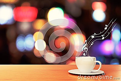 Cup of coffee on a wooden table in a cafe and musical notes Stock Photo