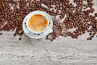 Cup of delicious espresso coffee with beans Stock Photo