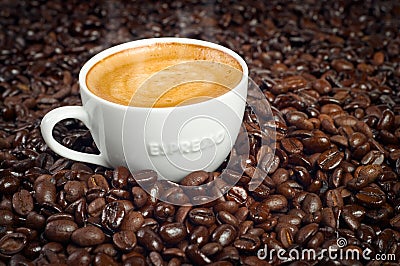 Cup of Espresso in Dark Roasted Coffee Beans Stock Photo