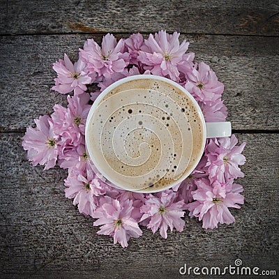 A cup of fresh coffee on a bunch of flowers Stock Photo