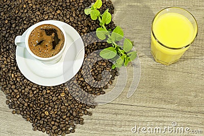 Cup of fresh coffee, coffee beans, orang juice and mint tea leaves Stock Photo