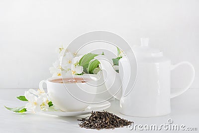 Cup of green jasmin tea white jasmine flowers, teapot. Teatime. Stock Photo