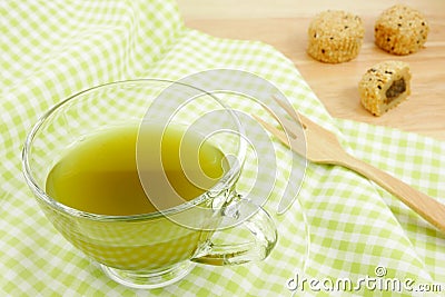 The cup of green tea on green cotton fabric Stock Photo