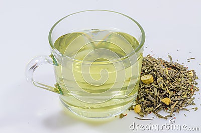 Cup of green tea whit ginseng pieces Stock Photo