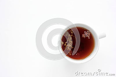 Cup of herbal oregano tea with dry marjoram flowers on white table background with copy space. Stock Photo