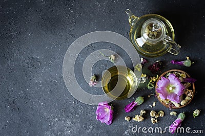 Cup of hollyhock tea with dried and fresh hollyhock blossom Stock Photo