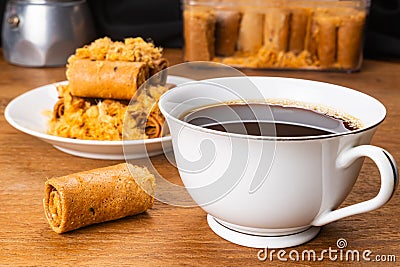 Cup of hot black coffee with a pile of dried shrodded pork crispy coconut roll Stock Photo