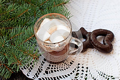 Cup of hot chocolate with marshmallows and decorative snowflake on the background of fir branches. Christmas card Stock Photo