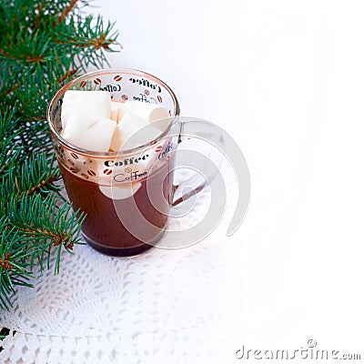 Cup of hot chocolate with marshmallows and decorative snowflake on the background of fir branches. Christmas card Stock Photo