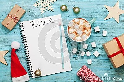 Cup of hot cocoa or chocolate with marshmallow, holiday decorations and notebook with to do list, christmas planning. Flat lay. Stock Photo