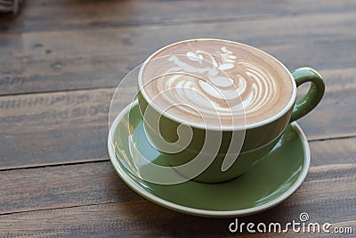 Cup of hot coffee latte with beautiful style on wood table Stock Photo