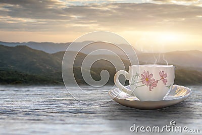 A cup of hot espresso coffee mugs placed with cookies on a wooden floor with morning fog and moutains with sunlight background, Stock Photo