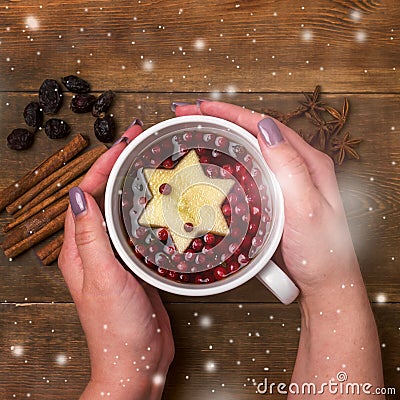 Cup of Hot Tea with Berry and Apple Cinnamon Spices Wooden background Christmas Food Concept Top View Female Hands Holding Cup of Stock Photo