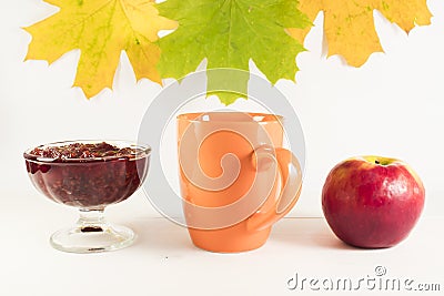 A cup of hot tea with raspberry jam and apple. Stock Photo