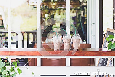 cup of iced coffee in a row on table in coffee shop. Stock Photo