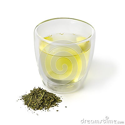 Cup of Japanese green tea and a heap of dried green tea leaves Stock Photo