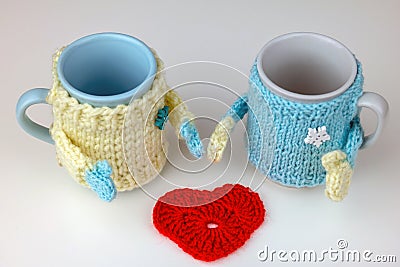 Cup in knitted sweater with hands Stock Photo
