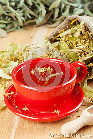 Cup of linden tea and flowers in canvas bag Stock Photo