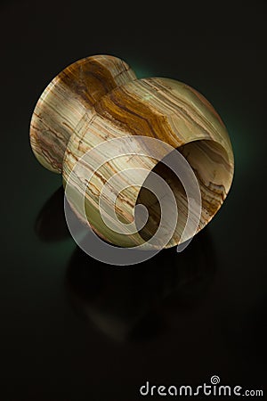 Cup made of onyx green on a black background with green backlight Stock Photo