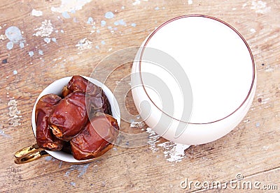 Cup of milk with ripe dates Stock Photo