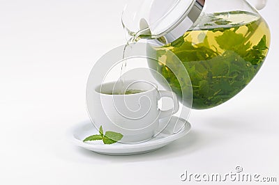 Cup with mint tea and teapot Stock Photo