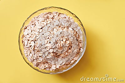 Cup of oatmeal. Delicious healthy breakfast. Yellow background Stock Photo