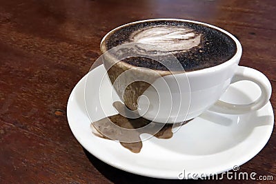 A cup of overflow black cocoa Stock Photo