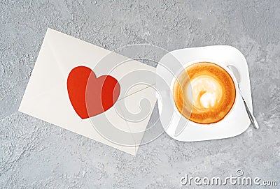 A cup of tasty cappucino and valentine letter with heart. Stock Photo