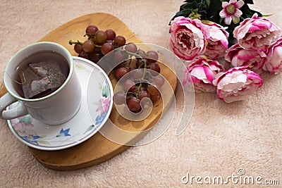 Cup of te and grapes Stock Photo