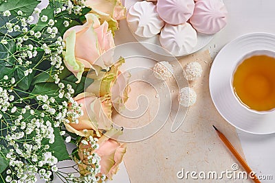 Mother's day. Cup of tea, bouquet of roses and sweets Stock Photo