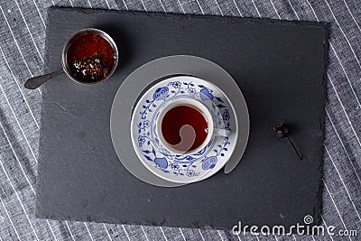 A cup of tea and cedar cone jam Stock Photo