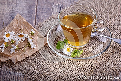 A cup of tea with chamomile on a wooden background. Alternative, traditional medicine Stock Photo