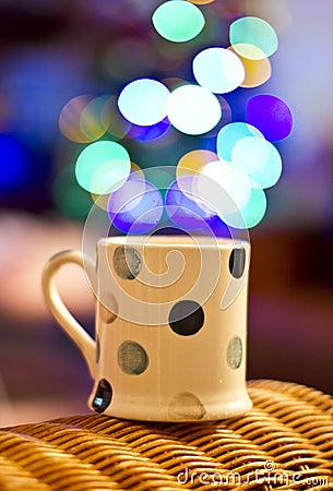 Cup of tea and Christmas tree bokeh. Stock Photo