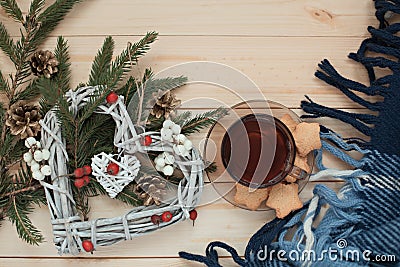 Cup of tea with cookies asterisks with a Christmas wreath heart of winter berries and blue with a white blanket Stock Photo