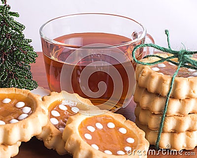 Cup of tea and cookies on wooden background with Christmas tree closeup Stock Photo