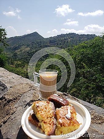 A cup of tea with a distinctive view, a peak of beauty and splendor, as well as clouds that seem like a blinding blanket. Stock Photo