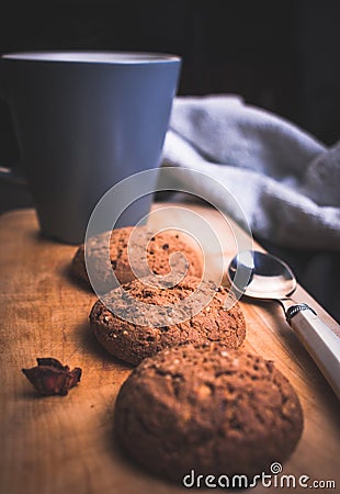 Cup of tea with homemade oatmeal cookies and spoon on the wooden Stock Photo